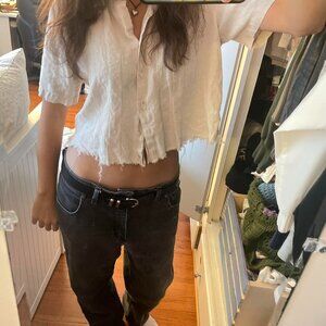 White linen button-up shirt with a distressed, cropped fit